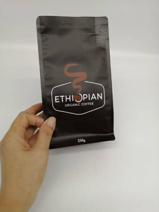 Hand holding a pack of Ethiopian Organic coffee beans